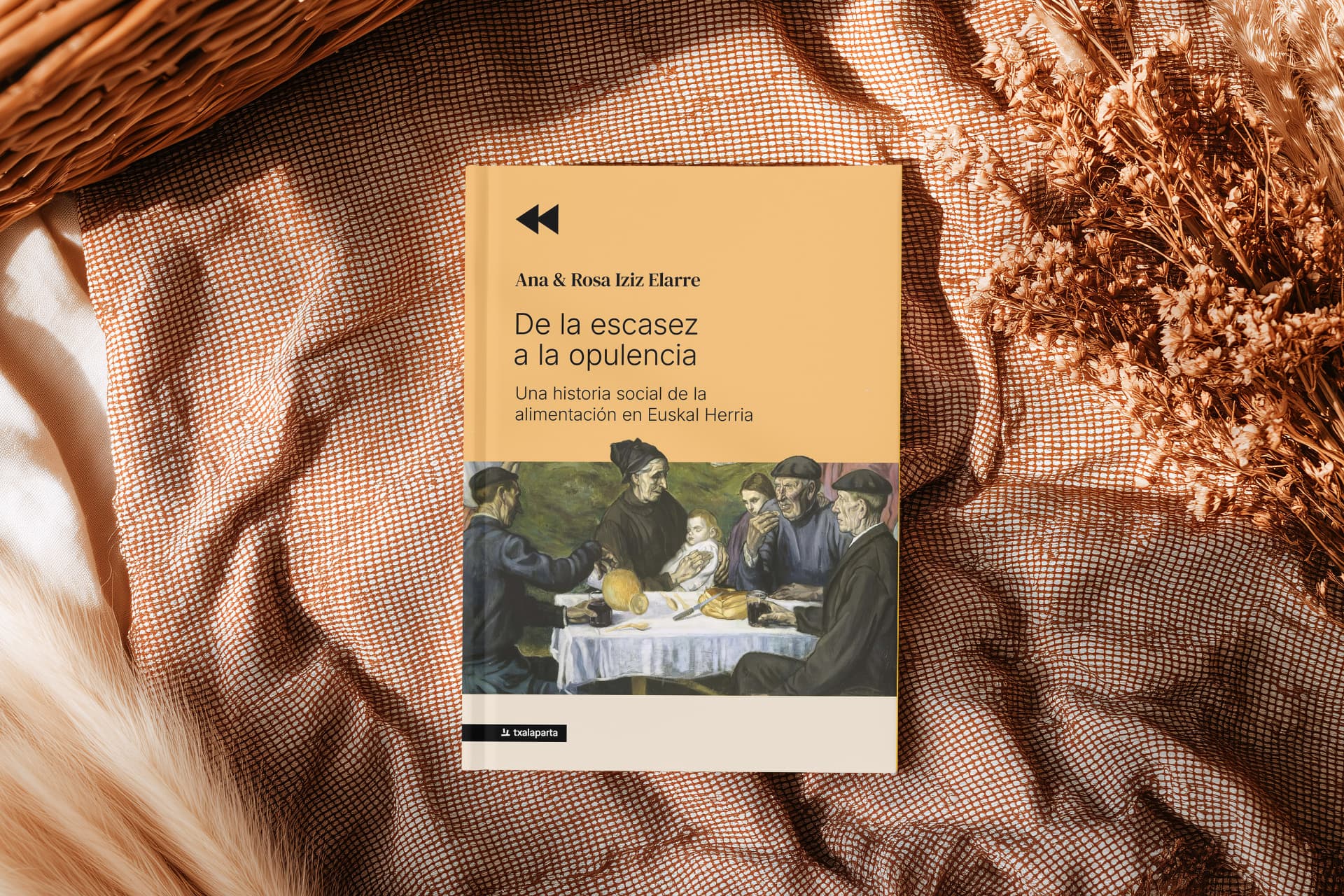El libro De la escasez a la opulencia sobre una tela de cuadros